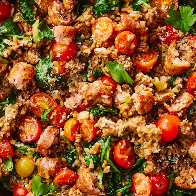 one pot farro with chicken sausage and tomatoes topped with fresh herbs