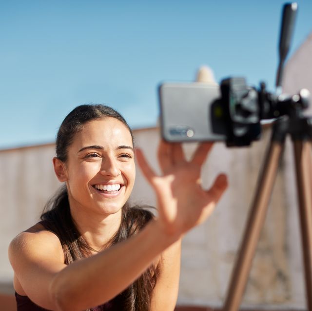 one young woman adjusting the camera before teaching online