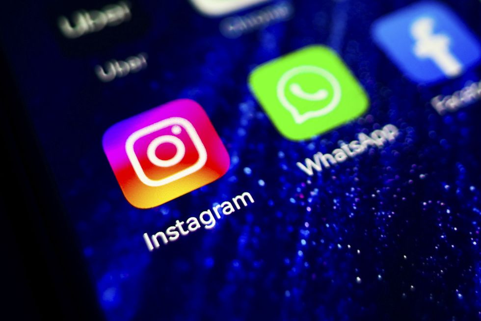 instagram app logo is displayed on a mobile phone screen for illustration