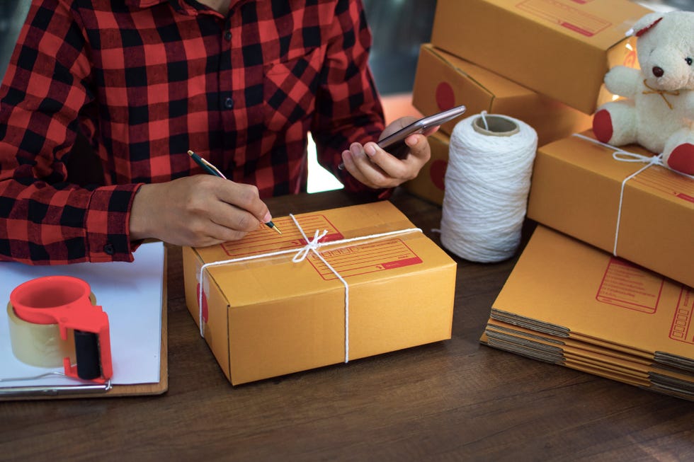 online shopping young start small business in a cardboard box at work the seller prepares the delivery box for the customer, online sales, or ecommerce