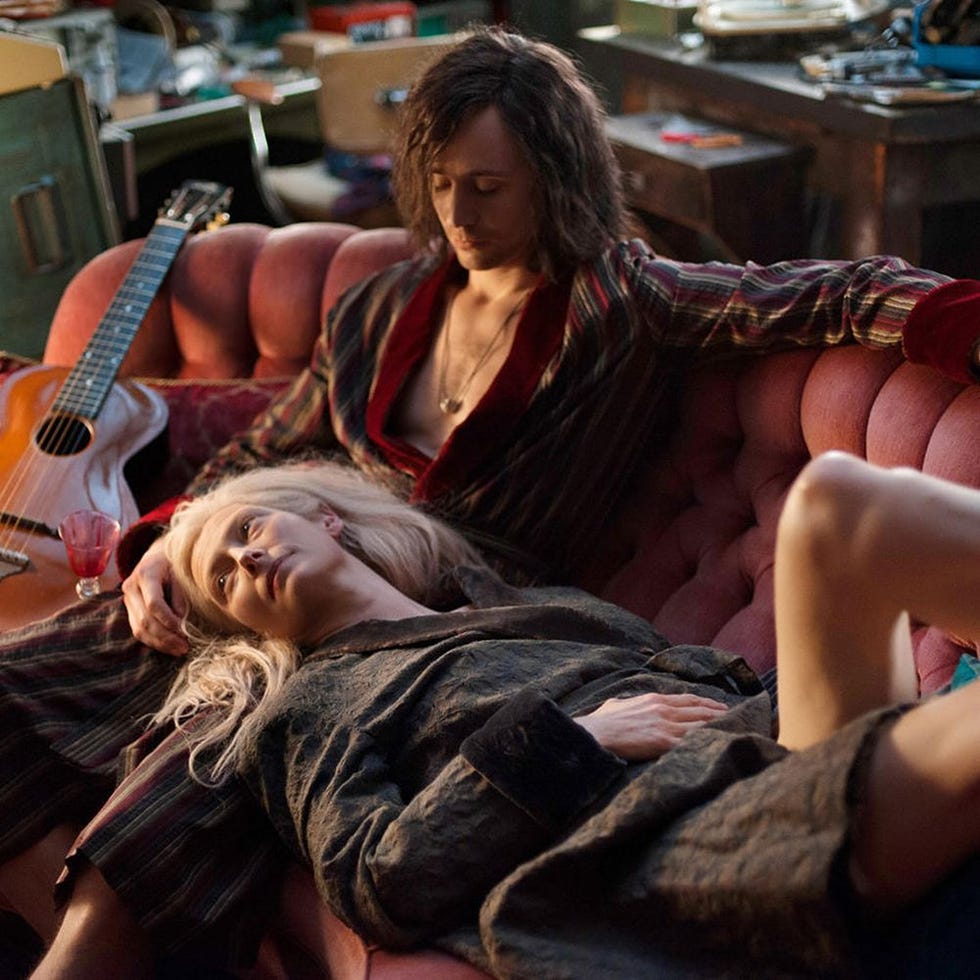 a couple lounging on a couch in a relaxed setting