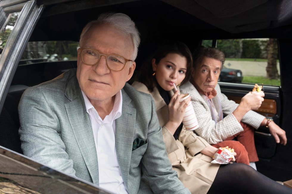 steve martin as charles, selena gomez as mabel, martin short as oliver, sitting in the back of a car together in a scene from only murders in the building season 4 episode 1