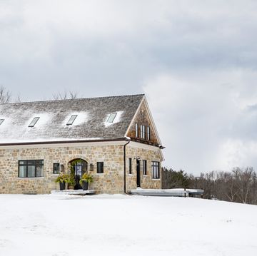 limestone farmhouse in port perry, ontario homeowners interior designer angela wheeler and husband josh malcolm buildingwalnutfarm winter, christmas, snow exterior
