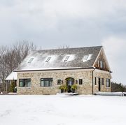 limestone farmhouse in port perry, ontario homeowners interior designer angela wheeler and husband josh malcolm buildingwalnutfarm winter, christmas, snow exterior