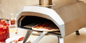 pizza going into ooni koda outdoor pizza oven