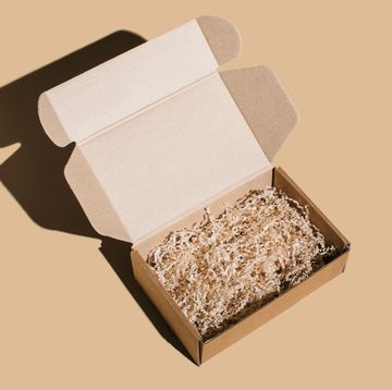 open blank brown cardboard box on beige background