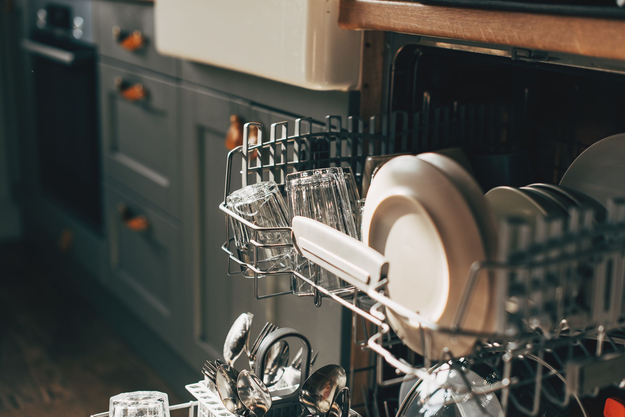 https://hips.hearstapps.com/hmg-prod/images/open-dishwasher-with-clean-utensils-in-it-royalty-free-image-1700077040.jpg