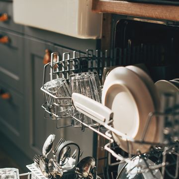 open dishwasher with clean utensils in it