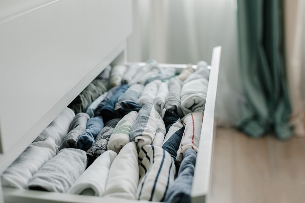 open drawer with kids t shirts. vertical storage of clothing