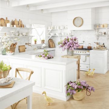 white farmhouse kitchen with open shelving displaying ironstone collection, antique cutting boards