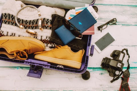 open suitcase with winter travel items