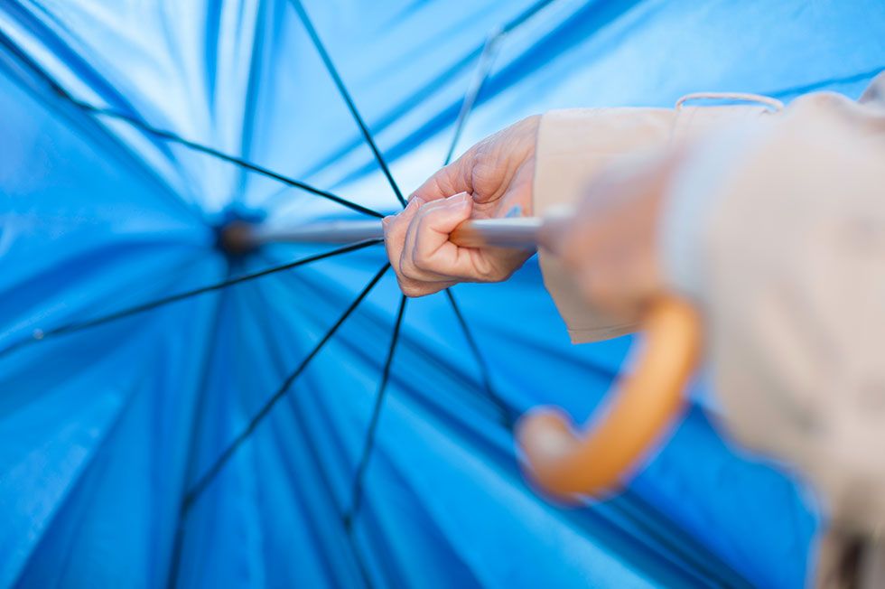 Blue, Umbrella, Hand, Fashion accessory, Electric blue, Finger, Gesture, Bicycle tire, Bicycle part, 