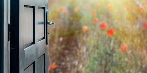 Opened door concept to beautiful and imaginary poppies field