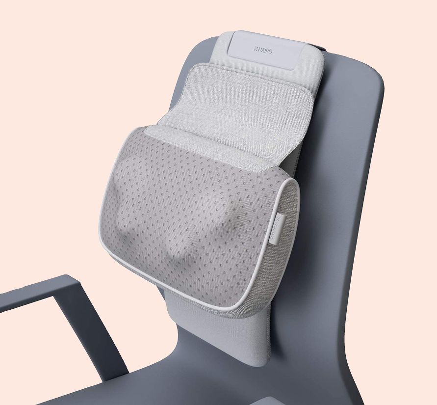 back massager attached to chair with light pink background
