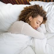 tired african american woman sleeping in bed at home