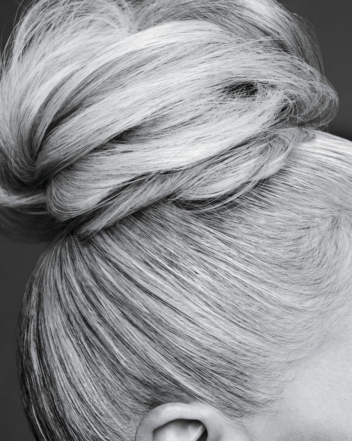 cropped shot of a mature woman's grey haired bun