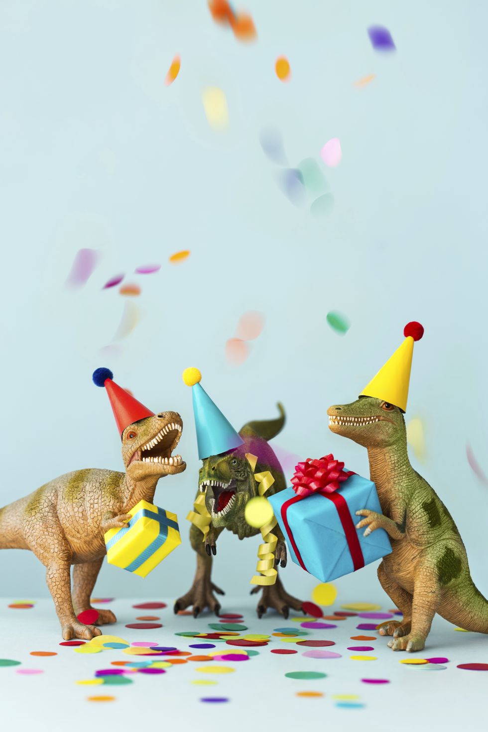 dinosaurs holding birthday presents