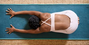 woman practicing yoga at home in her living room