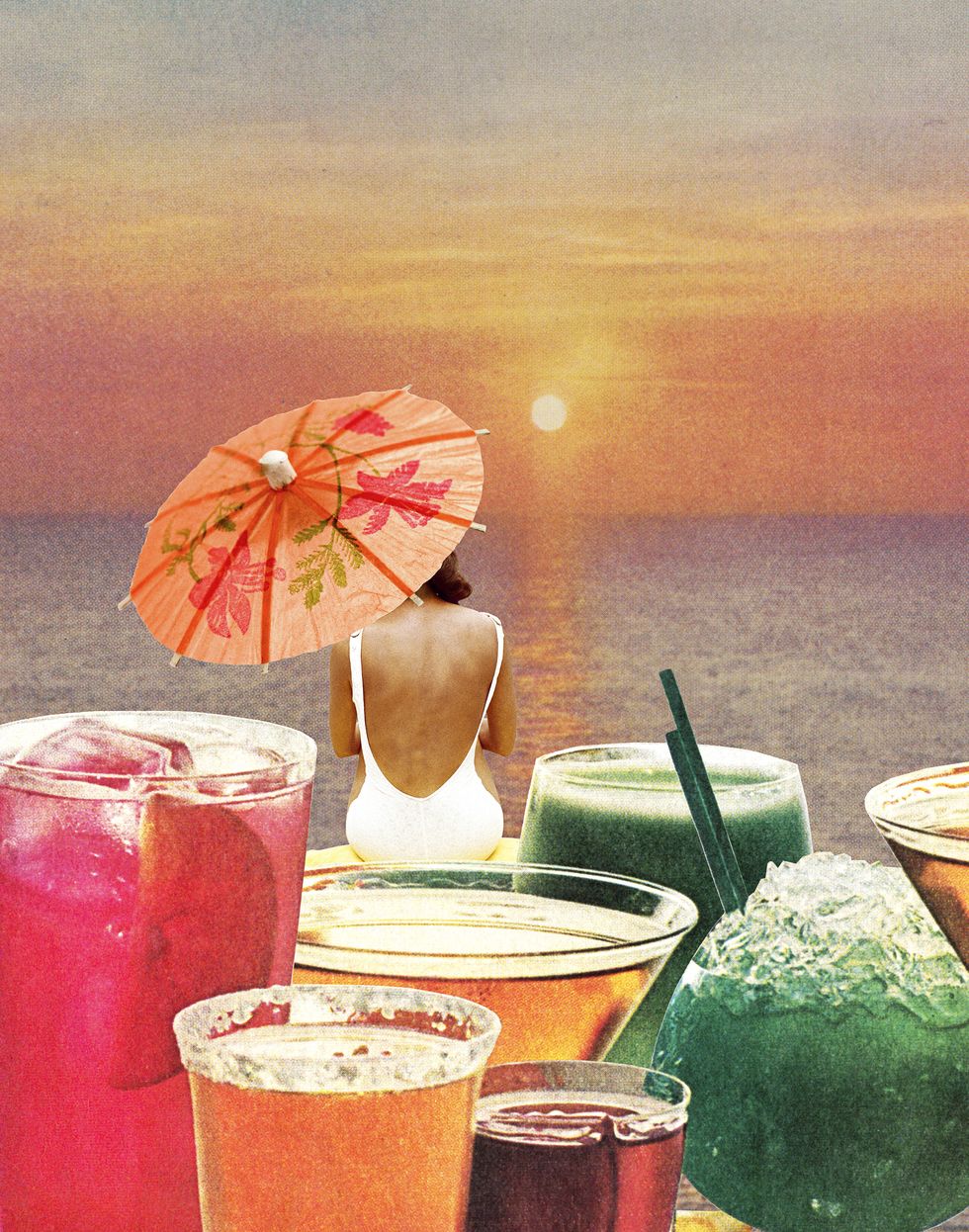 woman sitting on beach surrounded by tropical drinks