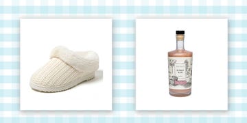 a whit knit slipper next to a glass bottle of light pink bubble bath