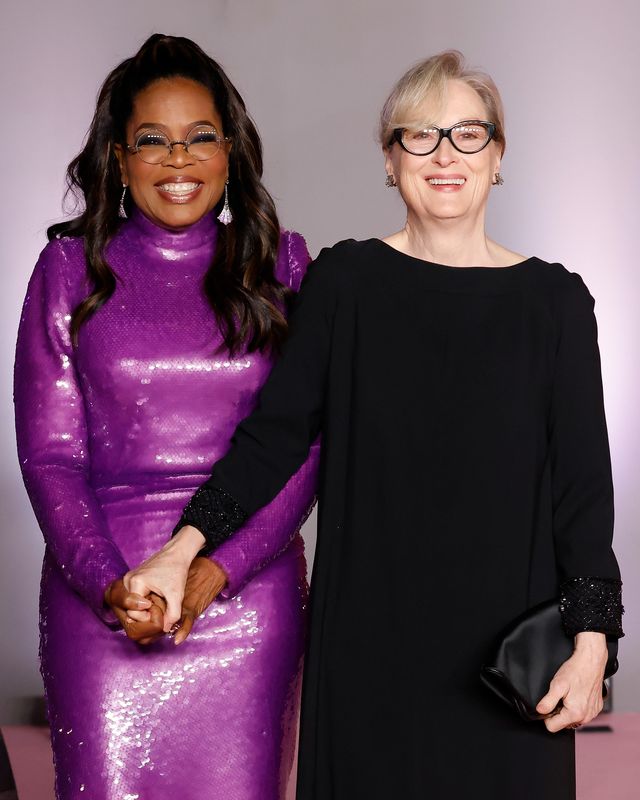 Meryl Streep and Oprah Winfrey smile and hug on the red carpet