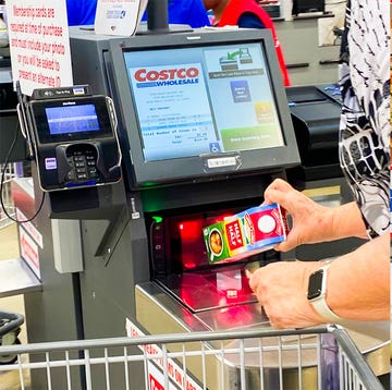 Costco a person holding a can of soda next to a hot dog and a soda machine