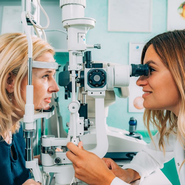 Optometrist Examining Patient At Clinic
