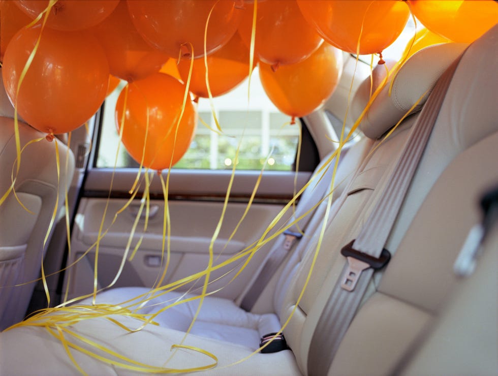 quarantine birthday - Orange balloons in back seat of car