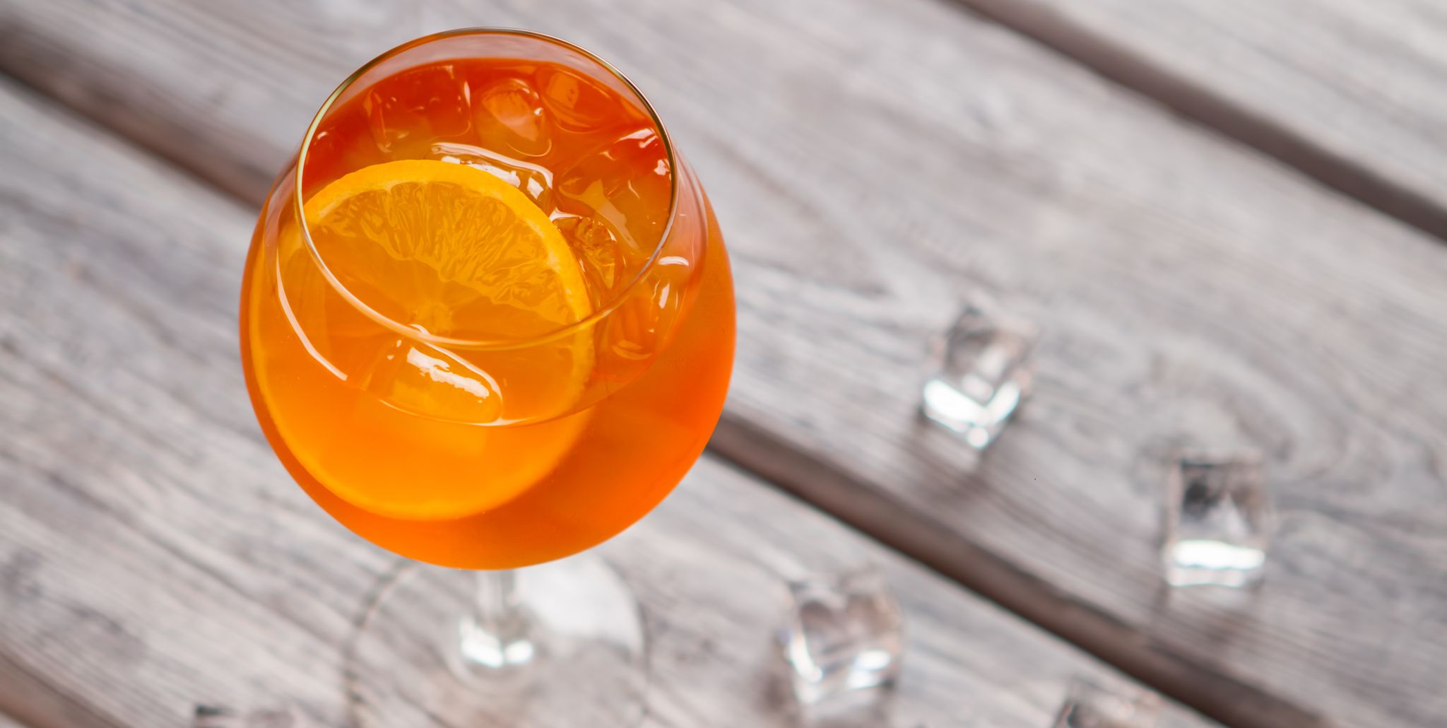 Orange cocktail in wineglass.