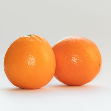 two oranges on white background