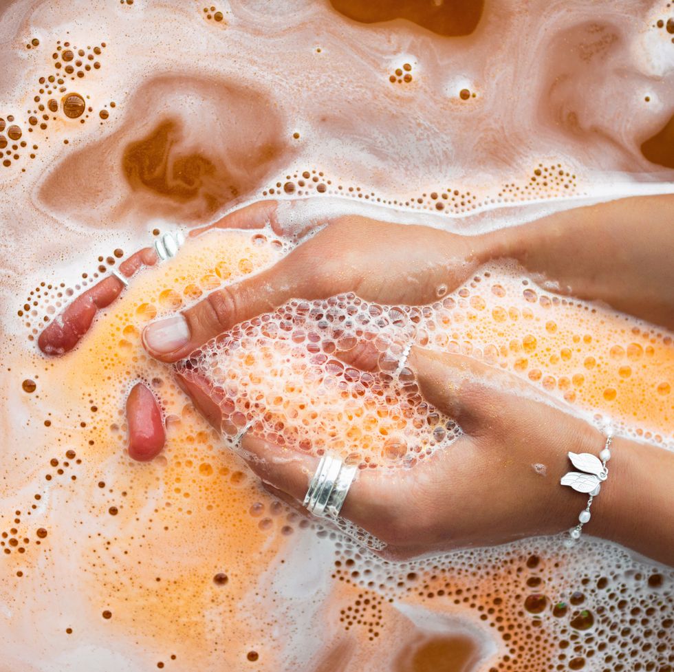 orange salt bath bomb dissolves in the hand