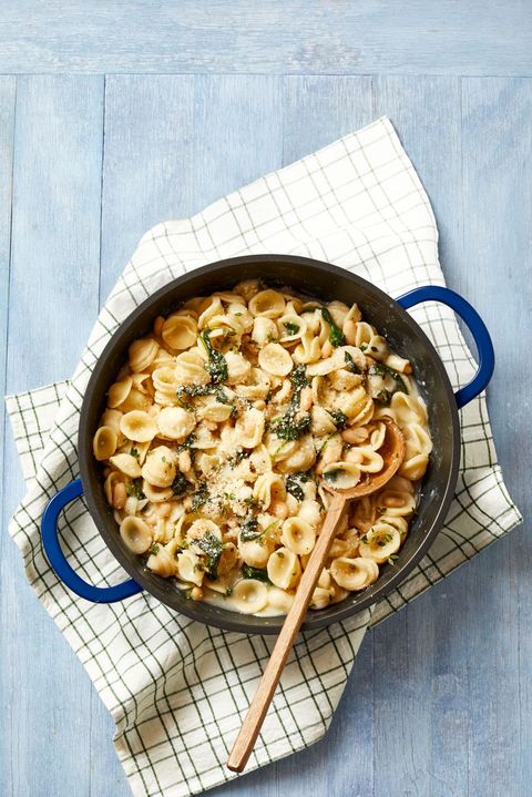 orecchiette pasta with white beans and spinach on a cast iron pot
