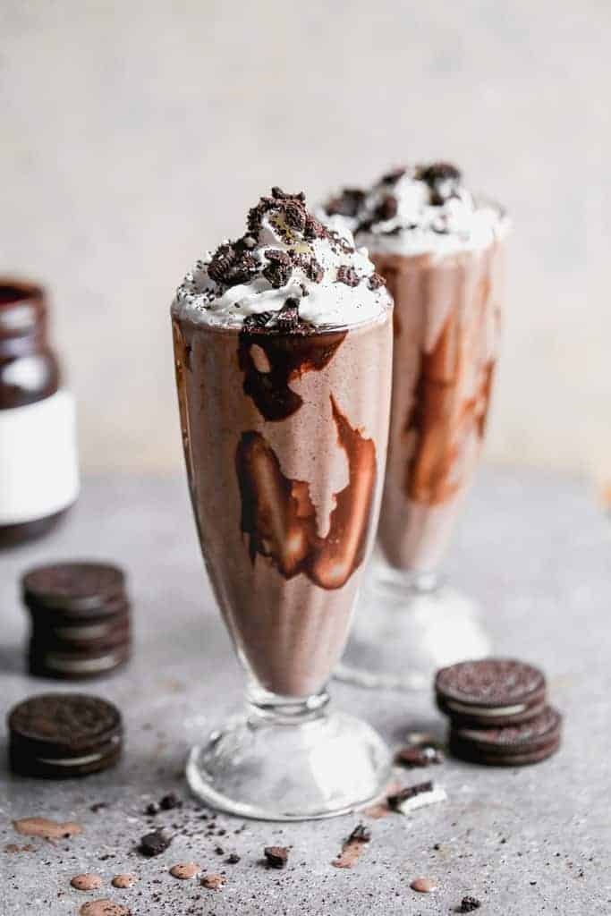 a glass jar with ice cream and chocolates in it