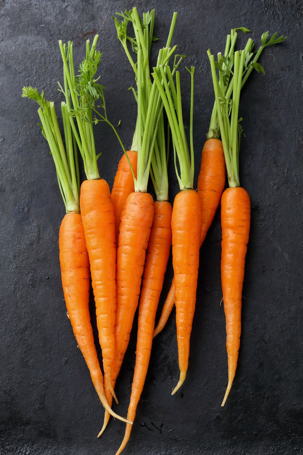 organic carrots on black background