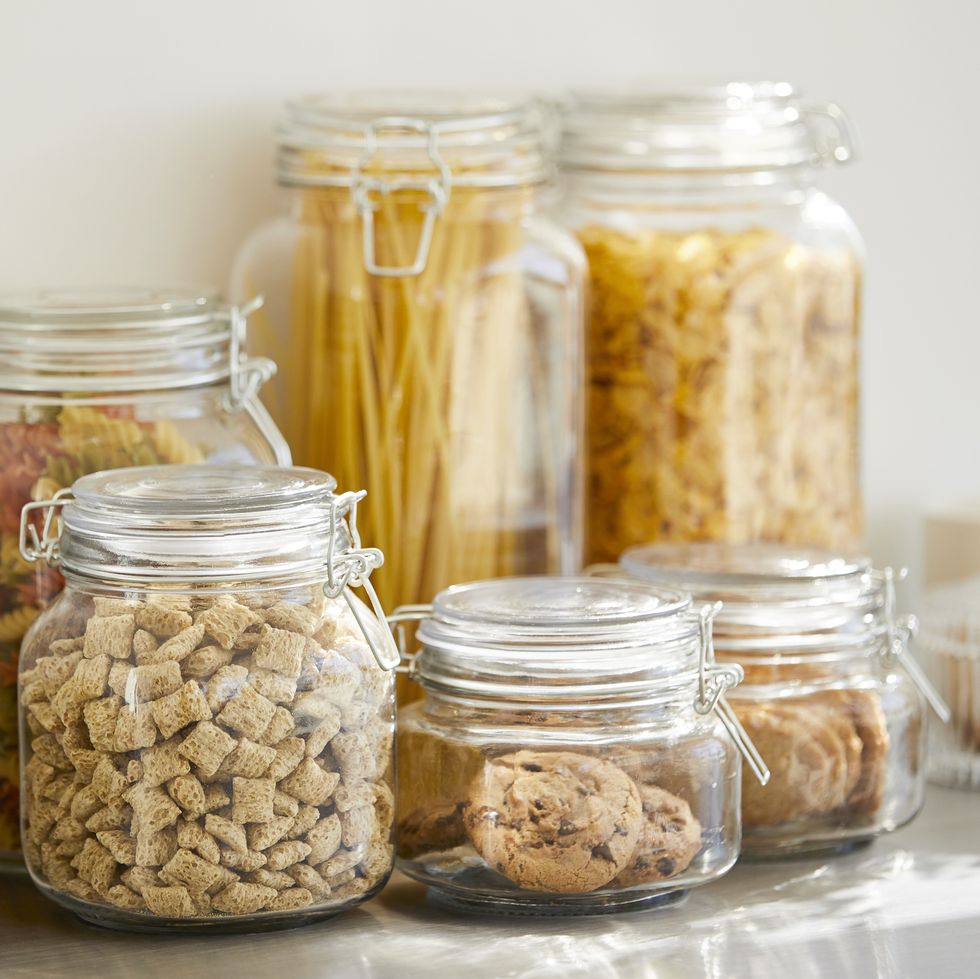 close up of various food in airtight jars groceries are seen through glass containers eatables are on table