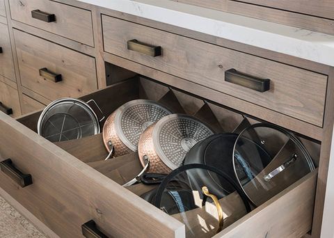 pots and pans in slats in a drawer