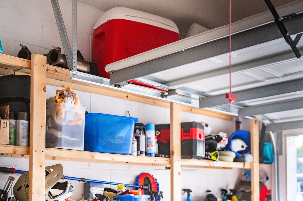 organized shelves inside a garage with an open door
