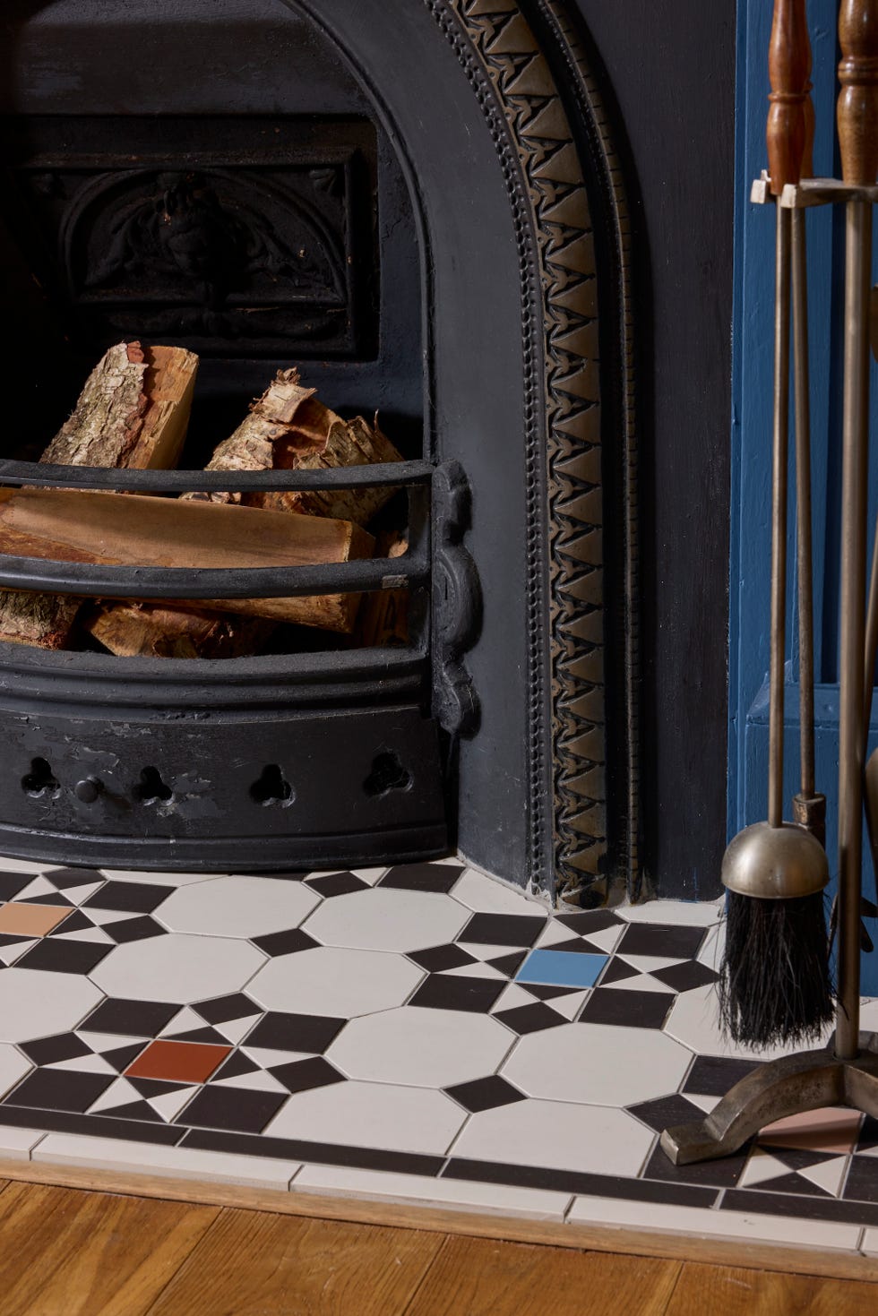 fireplace and tiled hearth with firewood and tools