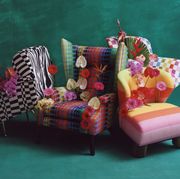 a collection of four multicolored pattern chairs with floral arrangements