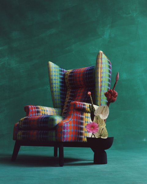 a wingback chair with a rainbow multicolored print