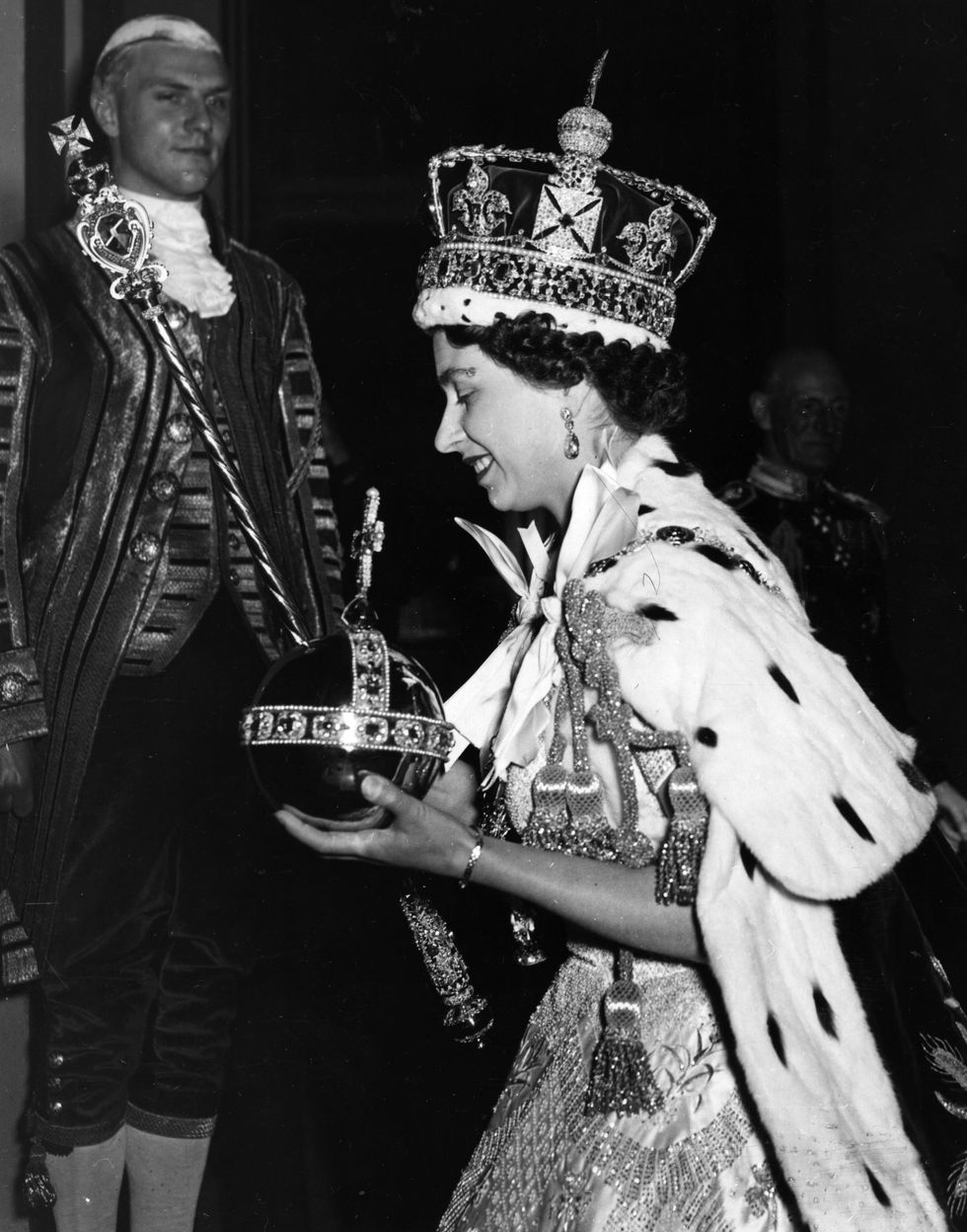 queen elizabeth ii wearing the imperial state crown and carrying the orb and sceptre, leaving the state coach and entering buckingham palace, after  the coronation  original publication picture post   6537   the coronation of queen elizabeth ii   pub 1953   photo by hulton archivegetty images