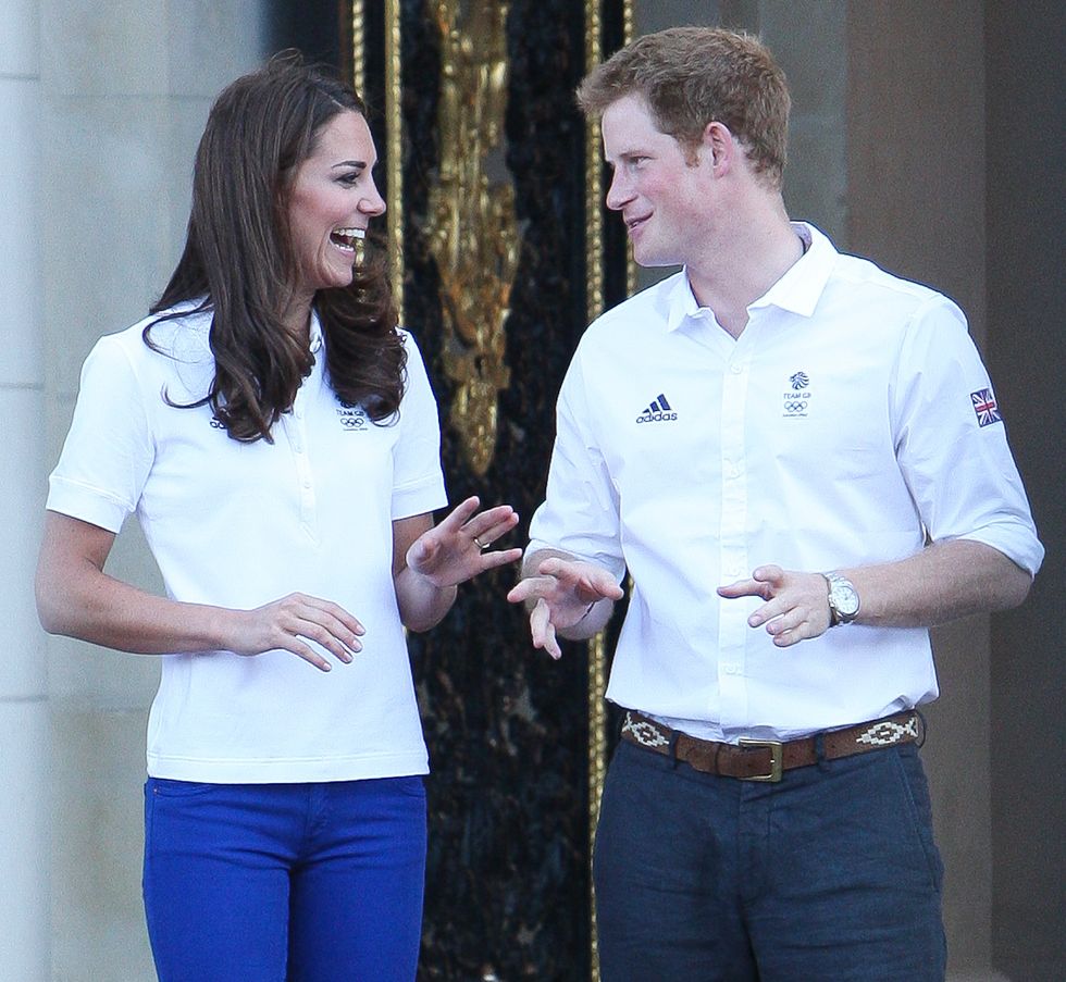 london, united kingdom   july 26 catherine duchess of cambridge and prince harry greet the olympic torch as it arrives at buckingham palace on july 26, 2012 in london, england photo by alex mossfilmmagic