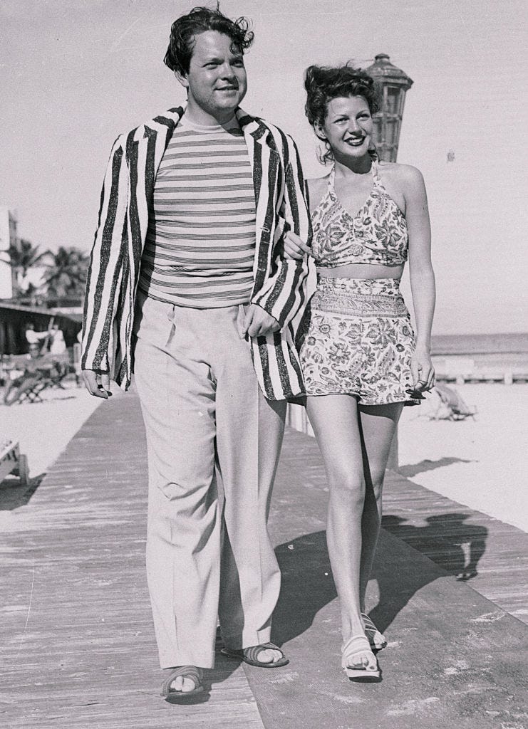 orson welles with rita hayworth strolling along boardwalk
