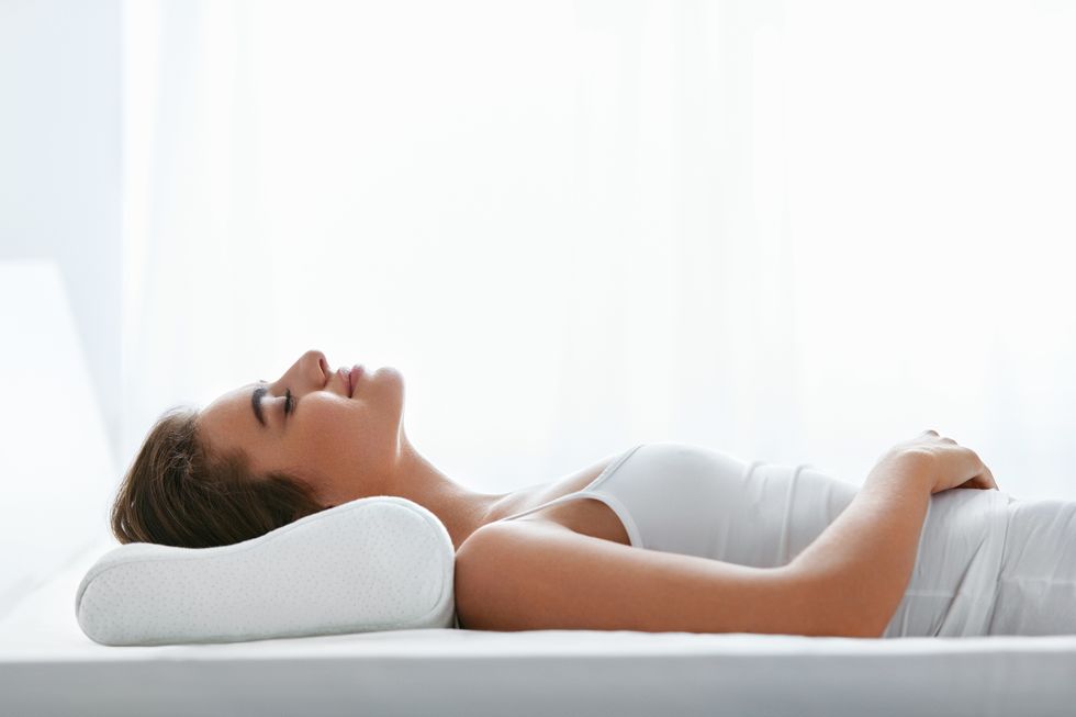 orthopedic pillow woman lying in bed