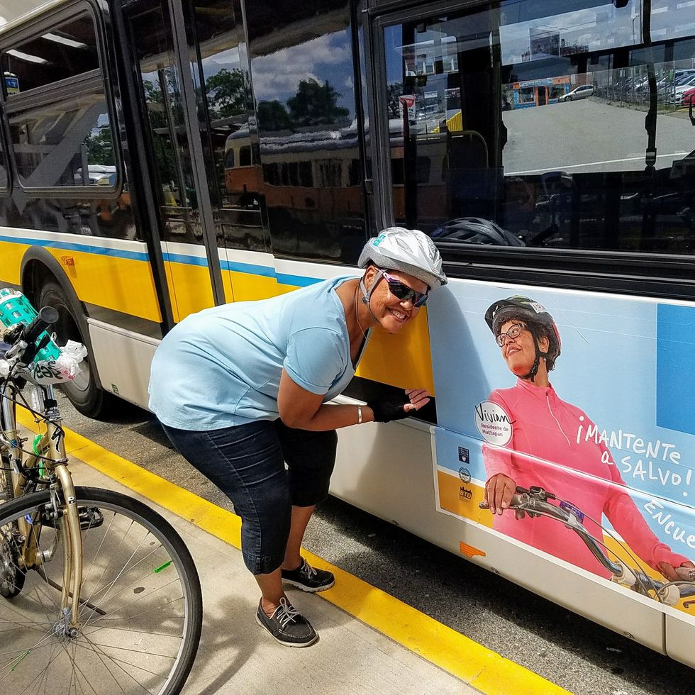 vivian ortiz points out her face on an i bike boston ad