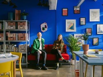 a vibrant seating area with two mannequins in a colorful interior
