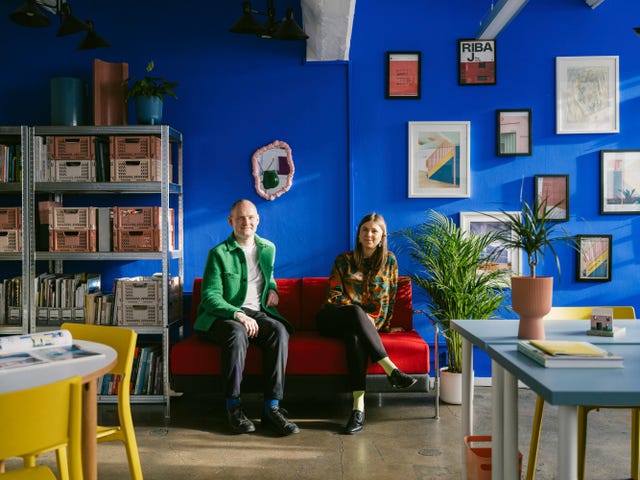 a vibrant seating area with two mannequins in a colorful interior