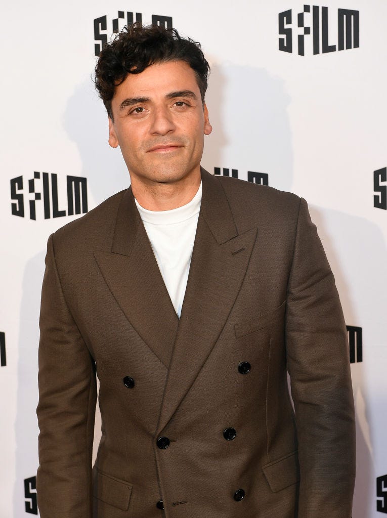 Oscar Isaac wears a brown suit and white T-shirt on the red carpet