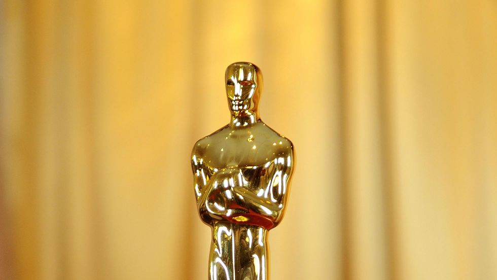 oscars statuette on red cushion