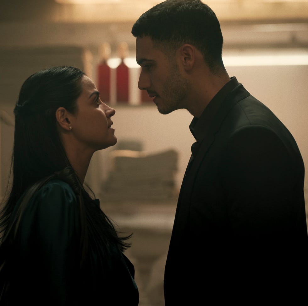 A tense moment between the two of them facing each other in a dimly lit environment A tense moment between the two of them facing each other in a dimly lit environment